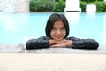 Young Asian girl having fun at swiming pool Royalty Free Stock Photo