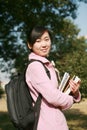 Young asian girl holding books