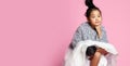 Young asian girl kid in long white skirt, grey fluffy sweater and black shoes sitting legs crossed and looks direct Royalty Free Stock Photo