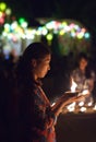 Asian woman light the candle to pray in Loi Krathong festival in Thailand