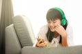 Young Asian girl listening to music with headphone and smarthphone Royalty Free Stock Photo