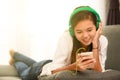 Young Asian girl listening to music with headphone and smarthphone Royalty Free Stock Photo