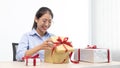 Young Asian girl opened a gift and smiled happily, Birthday surprise, Christmas surprise