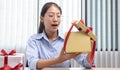 Young Asian girl opened a gift and smiled happily, Birthday surprise, Christmas surprise