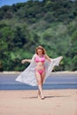 Young asian girl in pink bikini posing at tropical beach Royalty Free Stock Photo