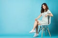 Young asian girl sitting on chair confidently