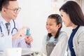 Girl smiling while doctor explain inhaler using method