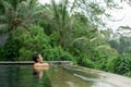 Young Asian Girl swimming in the infinity pool with beautiful view Royalty Free Stock Photo