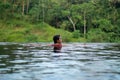 Young Asian Girl swimming in the infinity pool with beautiful view. She is taken photos from the back Royalty Free Stock Photo