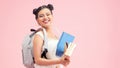 Young asian girl teen student wearing backpack hold pass isolated on pink background . Education in high school university college Royalty Free Stock Photo