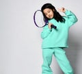 Young preteen asian girl in sportswear posing with tennis racket Royalty Free Stock Photo