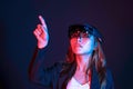 Young asian girl try augmented and virtural reality glasses hololens in the lab room. Mixed reality future technology concept