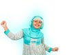 A young Asian girl wearing hijab listening to music on headphones dancing, smiling and looking at camera Royalty Free Stock Photo