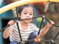 Young Asian girls are having fun clambering on rope nets in a playground Royalty Free Stock Photo