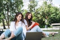 Young asian girls students working on laptop in park Royalty Free Stock Photo