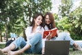 Young asian girls students working on laptop in city park Royalty Free Stock Photo