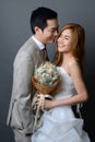 Young asian groom and bride posing and smiling in studio for wed Royalty Free Stock Photo