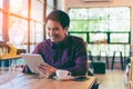 Young asian handsome businessman smiling while reading his table