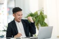 Young asian handsome man very happy and excited doing winner gesture with arms raised, smiling and screaming for success Royalty Free Stock Photo