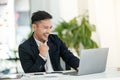 Young asian handsome man very happy and excited doing winner gesture with arms raised, smiling and screaming for success Royalty Free Stock Photo