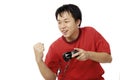 YOUNG ASIAN HAPPY WITH HIS WIN PLAYING ELECTRONIC GAMES Royalty Free Stock Photo