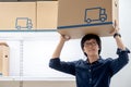 Young Asian happy man carrying cardboard box over head Royalty Free Stock Photo