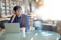 Young Asian man listening to music in library Royalty Free Stock Photo