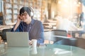 Young Asian man listening to music in library Royalty Free Stock Photo