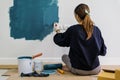 Young asian happy woman painting interior wall with paint roller Royalty Free Stock Photo