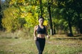 Young asian happy woman runner jogging in forest or city park. Morning jog. Active healthy lifestyle. attractive fitness female. Royalty Free Stock Photo