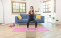 Young Asian healthy woman in sportswear doing fitness stretching exercises at home in the living room. home sport and recreation Royalty Free Stock Photo