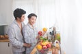 Homosexual couple prepairing breakfast in kitchen