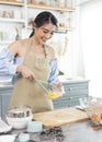 Young Asian housewife in kitchen cooking the bakery dough homemade Royalty Free Stock Photo