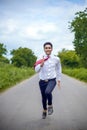 Young Asian Indian boy running on the road