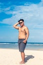 Young asian indonesian man on the beach of tropical Bali island, Indonesia. Royalty Free Stock Photo