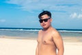 Young asian indonesian man on the beach of tropical Bali island, Indonesia. Royalty Free Stock Photo