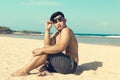 Young asian indonesian man on the beach of tropical Bali island, Indonesia. Royalty Free Stock Photo