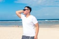 Young asian indonesian man on the beach of tropical Bali island, Indonesia. Royalty Free Stock Photo