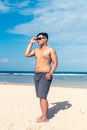 Young asian indonesian man on the beach of tropical Bali island, Indonesia. Royalty Free Stock Photo