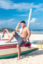 Young asian indonesian man relaxing on the beach of tropical Bali island, Indonesia. Royalty Free Stock Photo