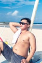 Young asian indonesian man relaxing on the beach of tropical Bali island, Indonesia. Royalty Free Stock Photo