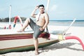 Young asian indonesian man relaxing on the beach of tropical Bali island, Indonesia. Royalty Free Stock Photo