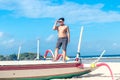 Young asian indonesian man relaxing on the beach of tropical Bali island, Indonesia. Royalty Free Stock Photo