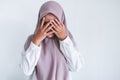 Young Asian Islam women wearing headscarf is covering her face with hand. Islam culture concept Royalty Free Stock Photo