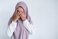 Young Asian Islam women wearing headscarf is covering her face with hand. Islam culture concept Royalty Free Stock Photo