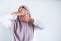 Young Asian Islam women wearing headscarf is covering her face with hand. Islam culture concept Royalty Free Stock Photo