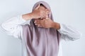 Young Asian Islam women wearing headscarf is covering her face with hand. Islam culture concept Royalty Free Stock Photo