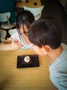 Young asian kids are enjoying Brownie with vanilla ice cream served on a plate at a restaurant Royalty Free Stock Photo