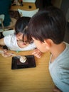 Young asian kids are enjoying Brownie with vanilla ice cream served on a plate. Royalty Free Stock Photo