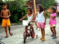 Young asian kids playing and riding a bike